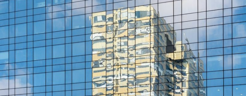 0591d2d5a3f0-Buildings-and-blue-sky-reflection-on-a-modern-glass-skyscraper.jpg